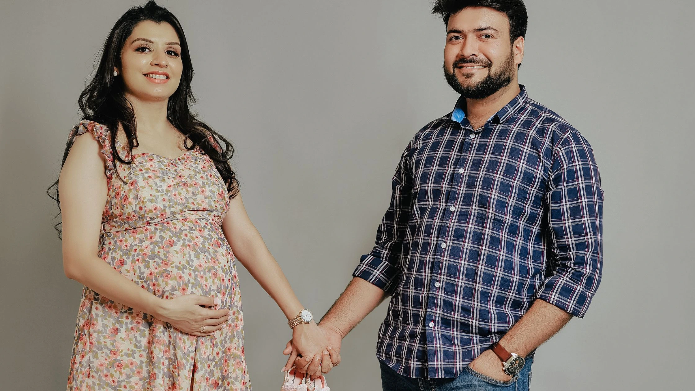 Stylish couple maternity photoshoot with red winter maternity wear by Indo Frames